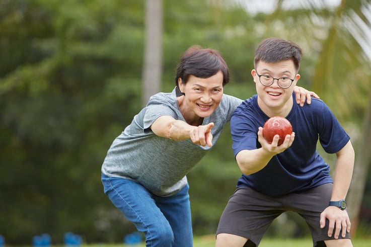 Photo of parent and child playing sport 