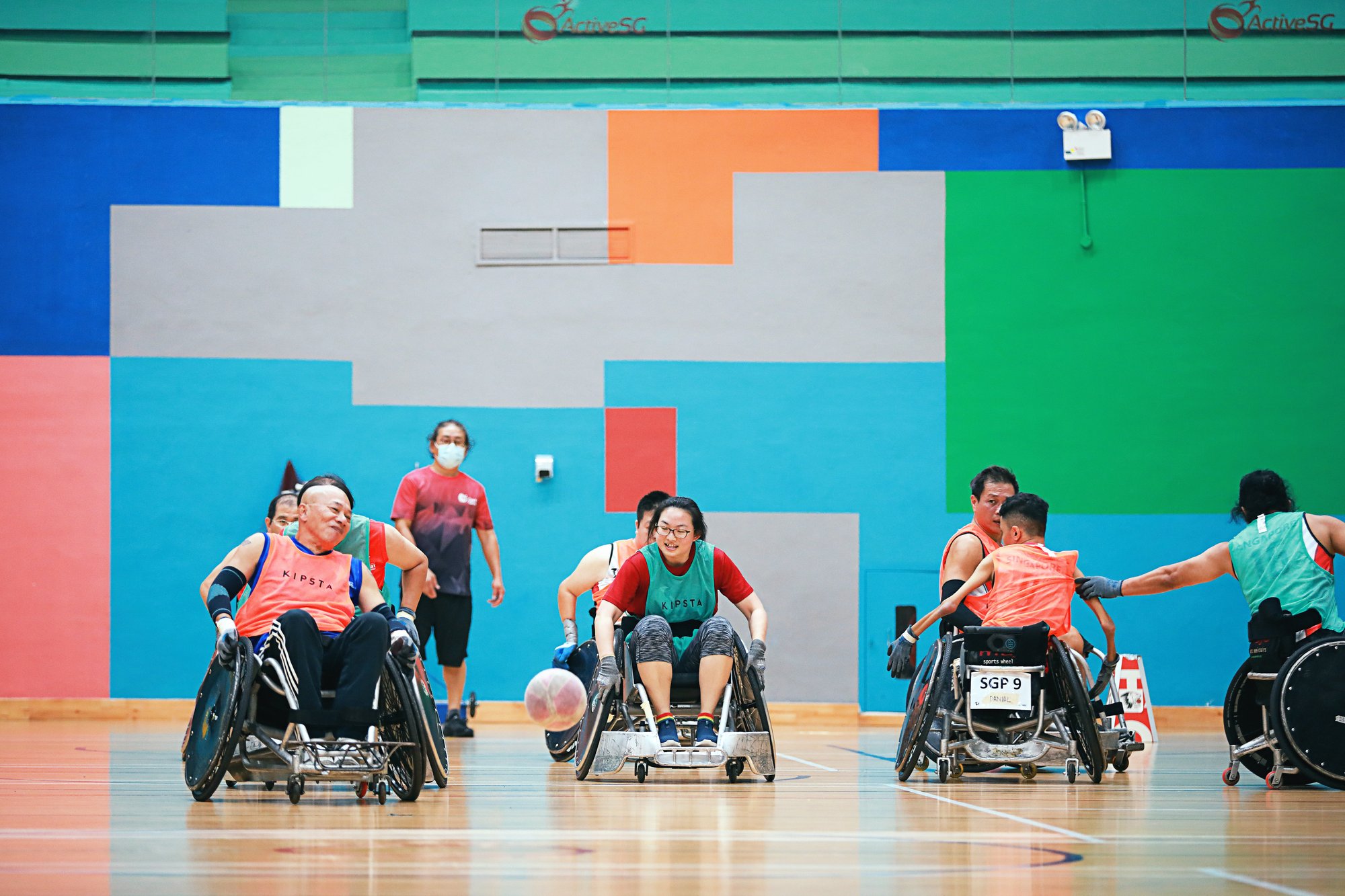 Photo of persons with and without disabilities playing wheelchair rugby
